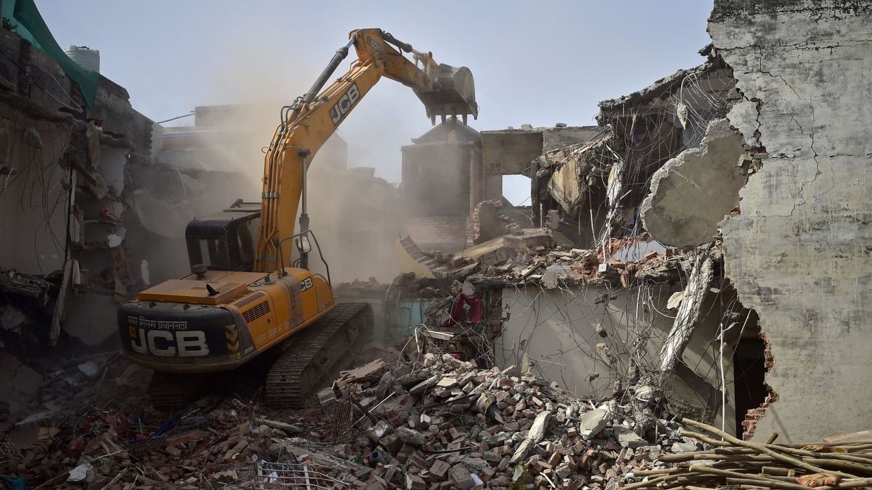 A bulldozer is being used to demolish the illegal structures of the residence of Javed Ahmed, a local leader who was allegedly involved in the  violent protests against BJP former spokeswoman Nupur Sharma's incendiary remarks about Prophet Mohammed, in Allahabad (UP) on June 12, 2022. (Photo: Getty Images)