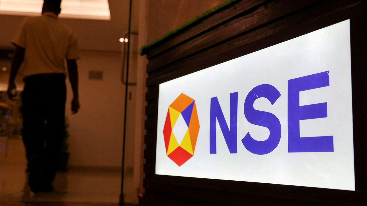 A man walks past the logo of the National Stock Exchange (NSE) in Mumbai. (Photo: Reuters)