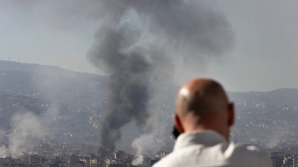 A man watches as smoke plumes rise over the city after Israeli forces conducted multiple airstrikes on the city's southern suburbs October 3, 2024 in Beirut, Lebanon. (Photo: Getty Images)