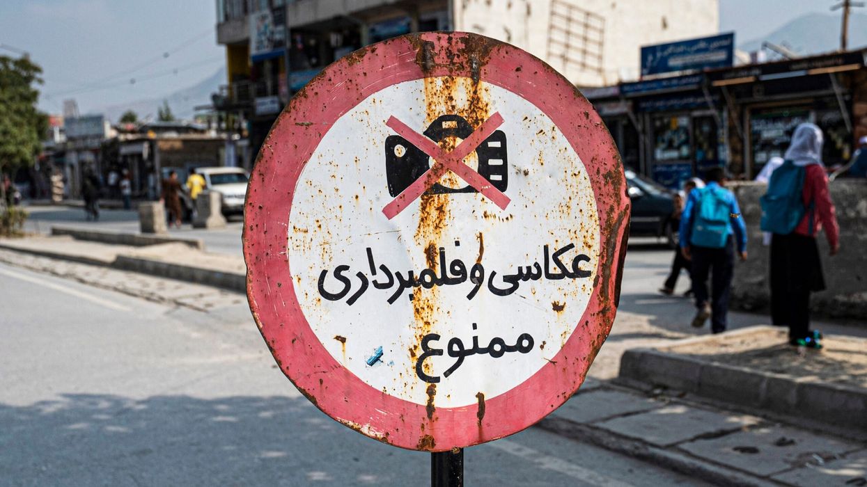 A signboard with the warning 'photography and video recording forbidden' is displayed along a street in Kabul on October 22, 2024. (Photo: Getty Images)