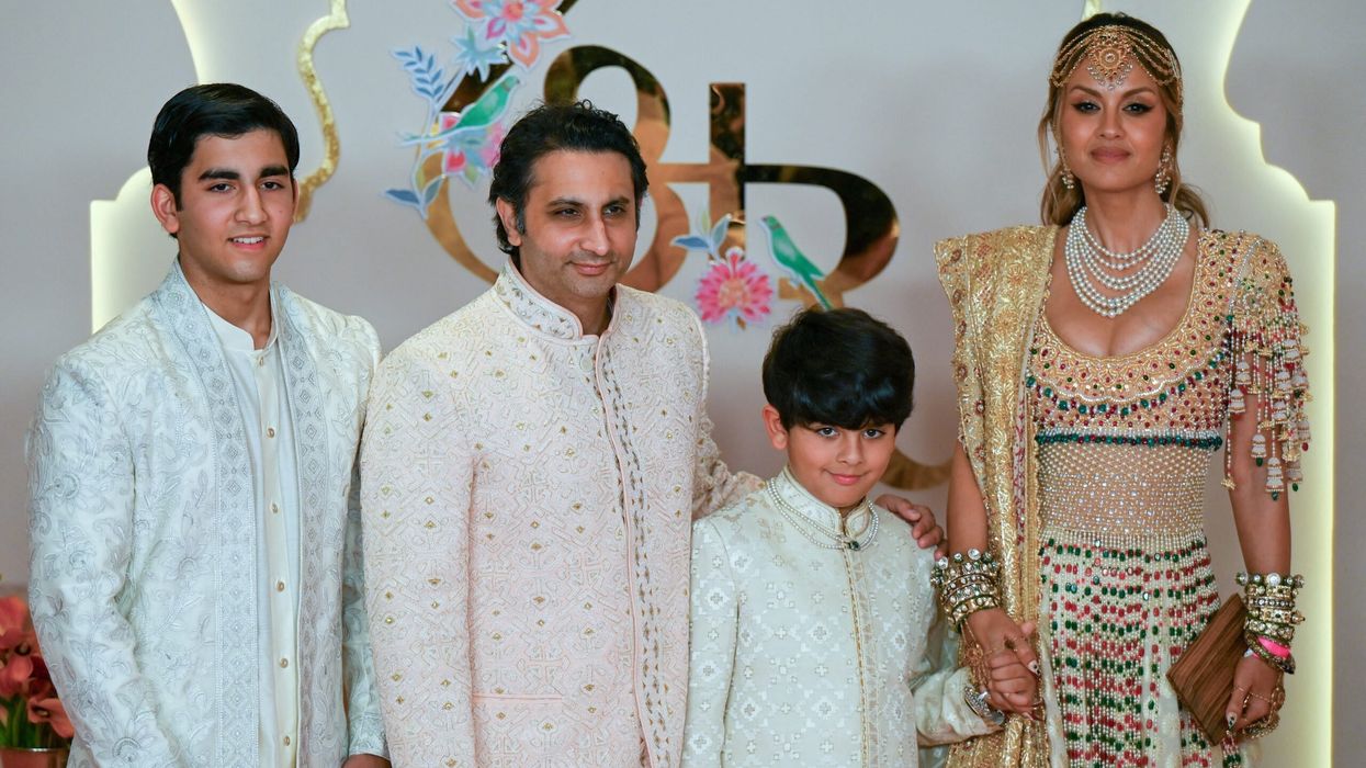Adar Poonawalla, his wife Natasha Poonawalla and their children pose for photos as they arrive to attend the wedding ceremony of Anant Ambani and Radhika Merchant in Mumbai on July 12, 2024. (Photo: Getty Images)