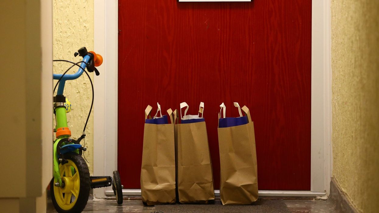 Bags containing meals for school children, delivered are pictured on the doorstep of an apartment in a block of flats on the Ivybridge estate in Twickenham, south west London, on October 26, 2020, following the British Government's announcement not extend free school meals for children during the school holidays and periods of lockdown. (Photo: Getty Images)