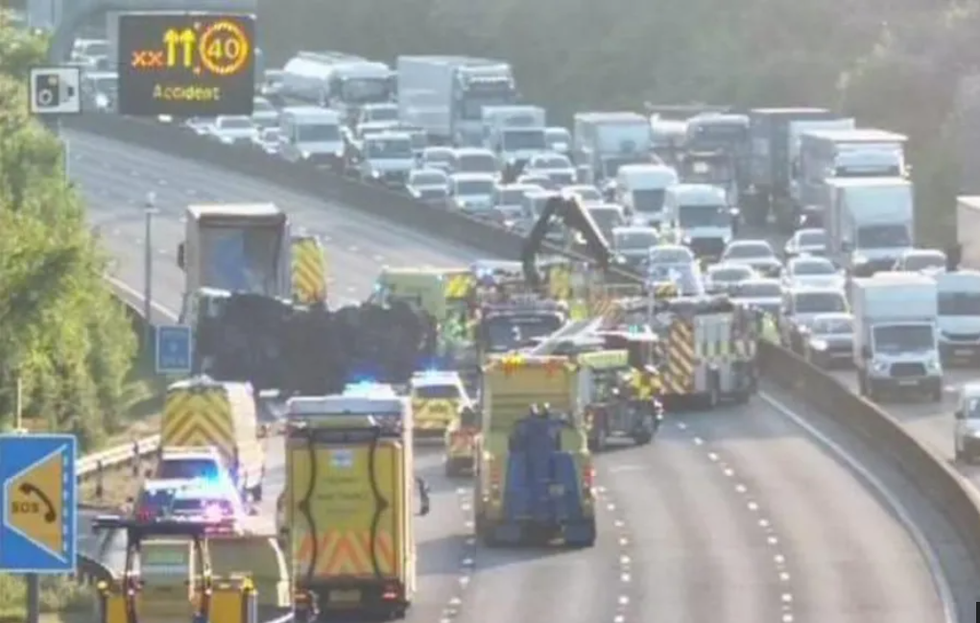 Delays on M25 as waste lorry overturns and spills fuel and waste