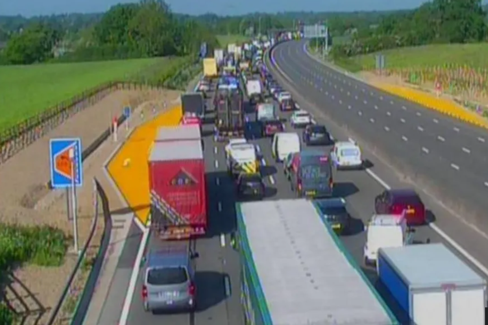Delays on M25 as waste lorry overturns and spills fuel and waste