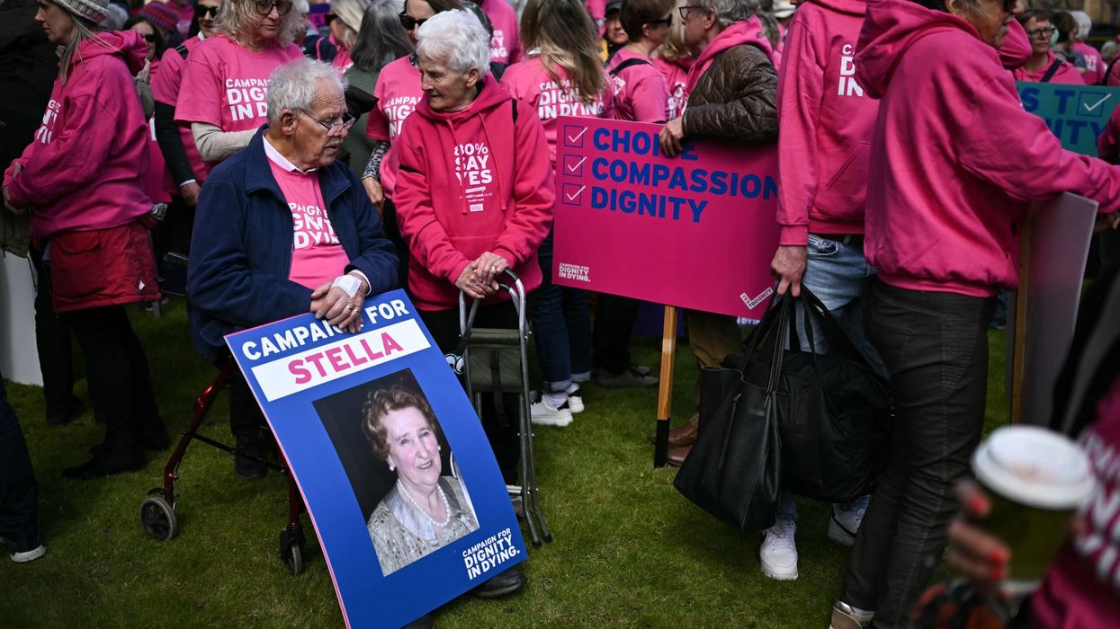 Disability campaigners from 'Dignity in Dying' hold placards as they demonstrate outside The Palace of Westminster on April 29, 2024, during a gathering in favour of the proposals to legalise assisted suicide in the UK. (Photo: Getty Images)