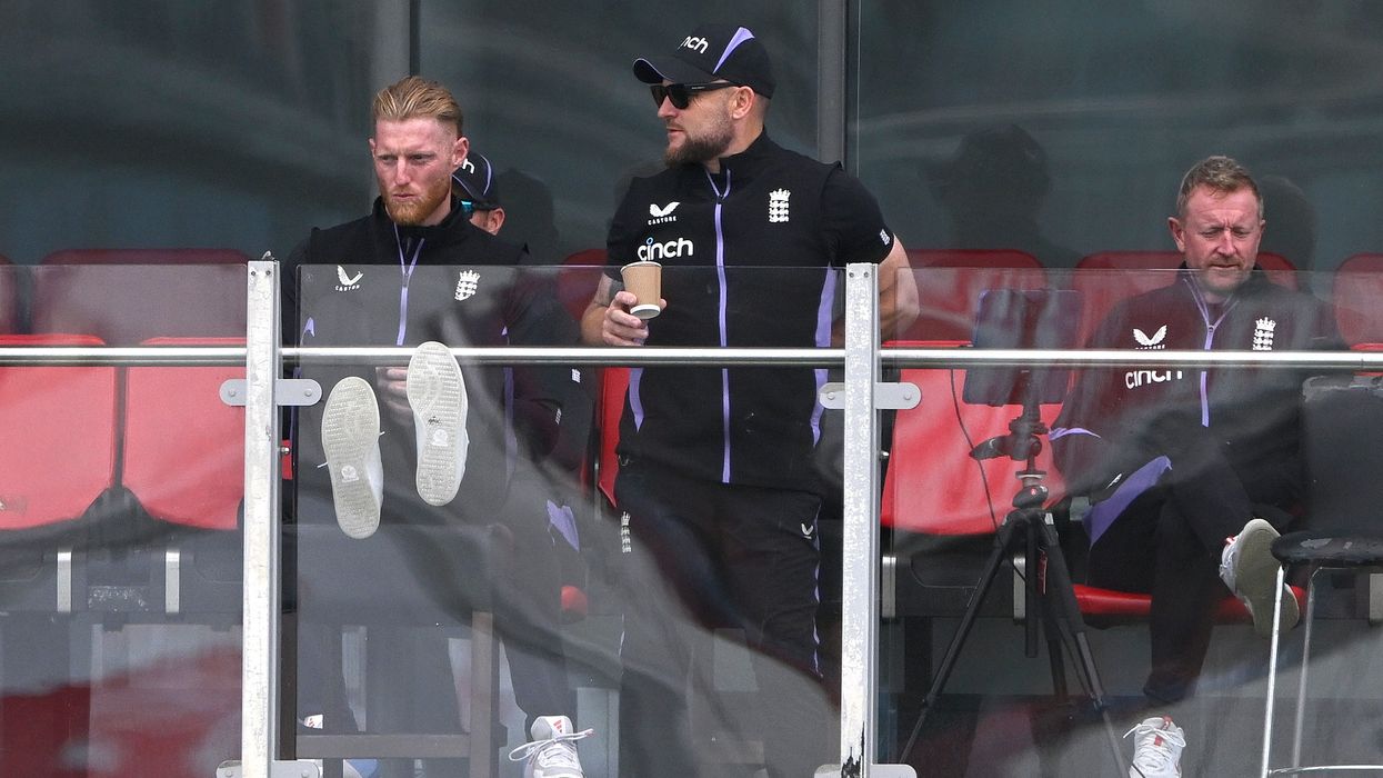 England captain Ben Stokes (l) puts his feet up on the team balcony alongside coaches Paul Collingwood (r) and Brendon McCullum during day one of the First Test between England and Sri Lanka on August 21. (Photo: Getty Images)