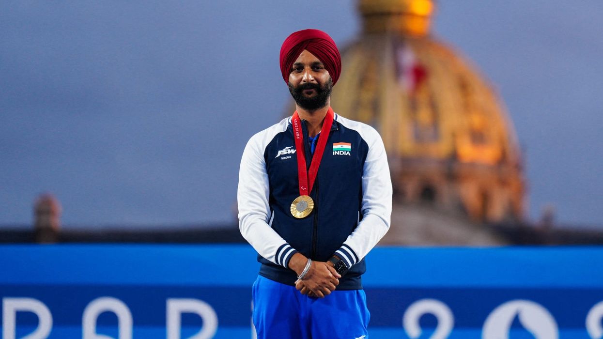 Gold medallist India's Harvinder Singh celebrates on the podium of the Men's individual classic open archery event during the Paris 2024 Paralympic Games on September 4. (Photo: Getty Images)
