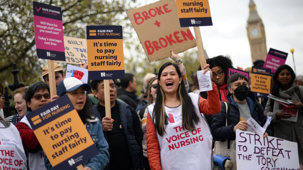 Healthcare workers hold placards as they demonstrate on Westminster Bridge, near to St Thomas' Hospital in London on May 1, 2023. (Photo: Getty Images)