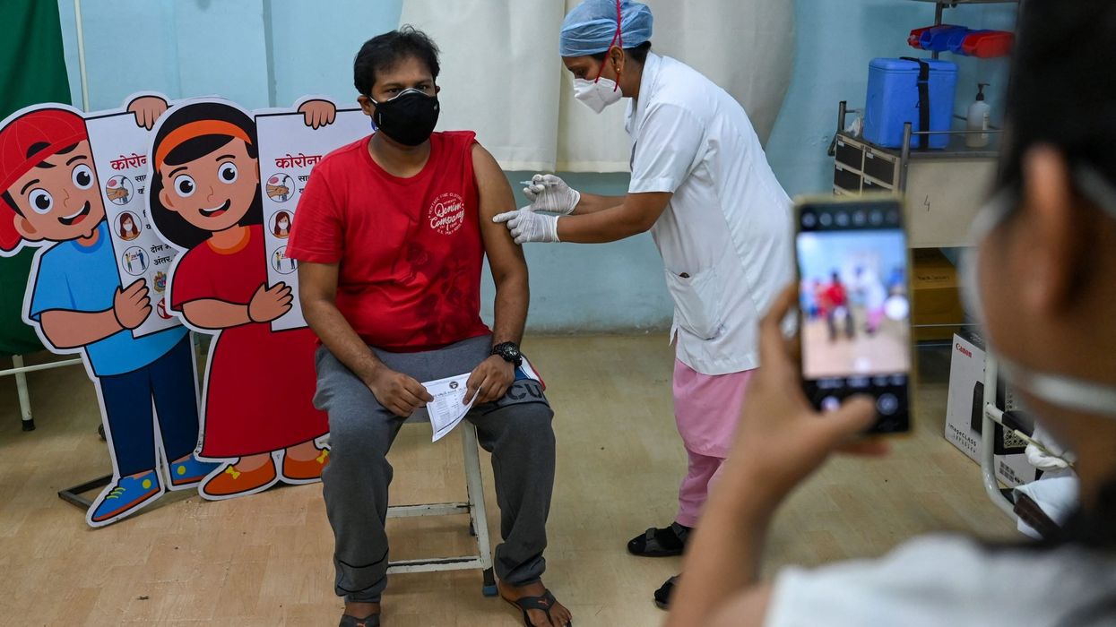 India expands faltering vaccine drive as new cases soar