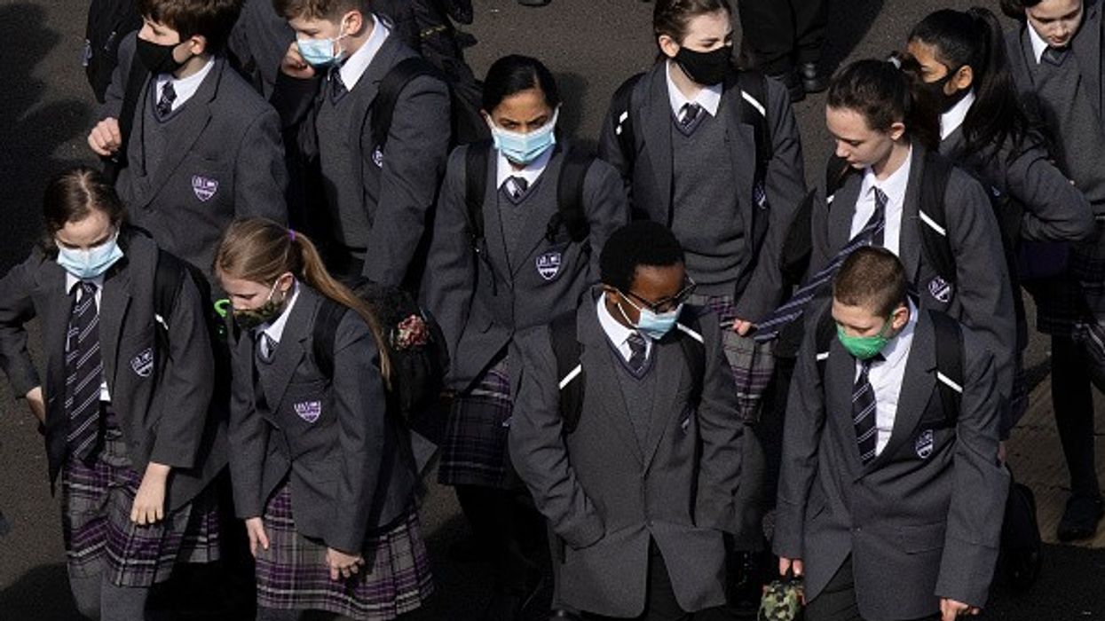 UK may offer jabs to under-18s soon as many schools shut early due to record numbers isolating