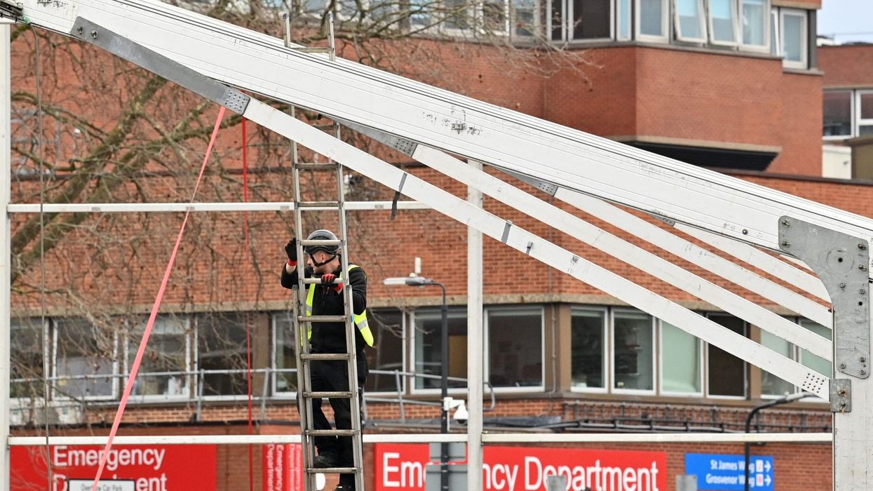 As virus surges, England builds temporary hospitals