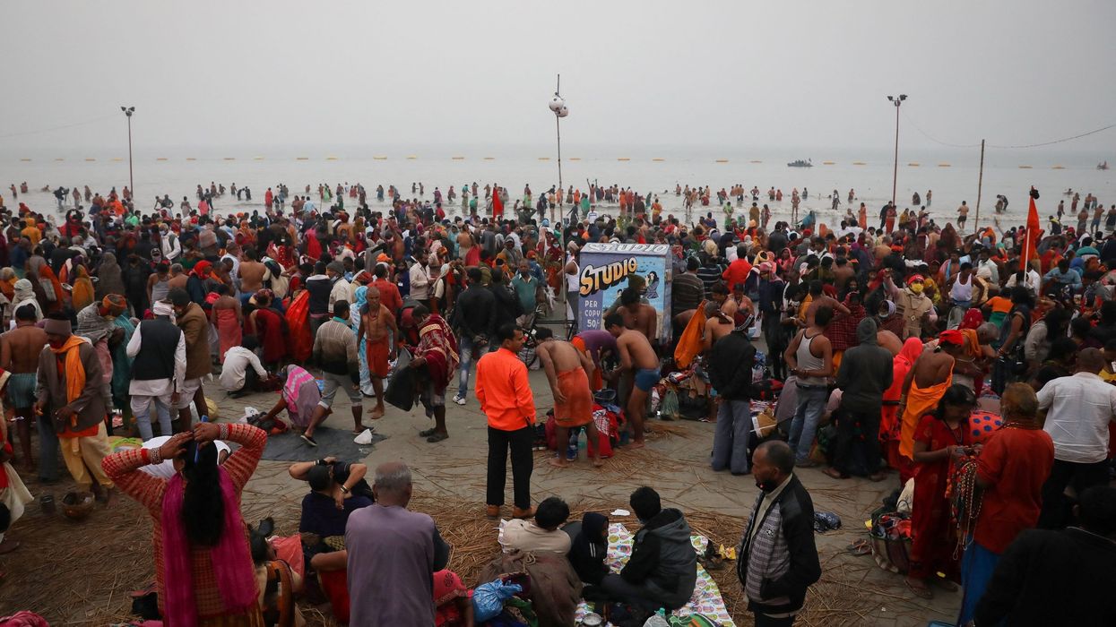 Hundreds of thousands gather for holy dip in India, defying Covid surge