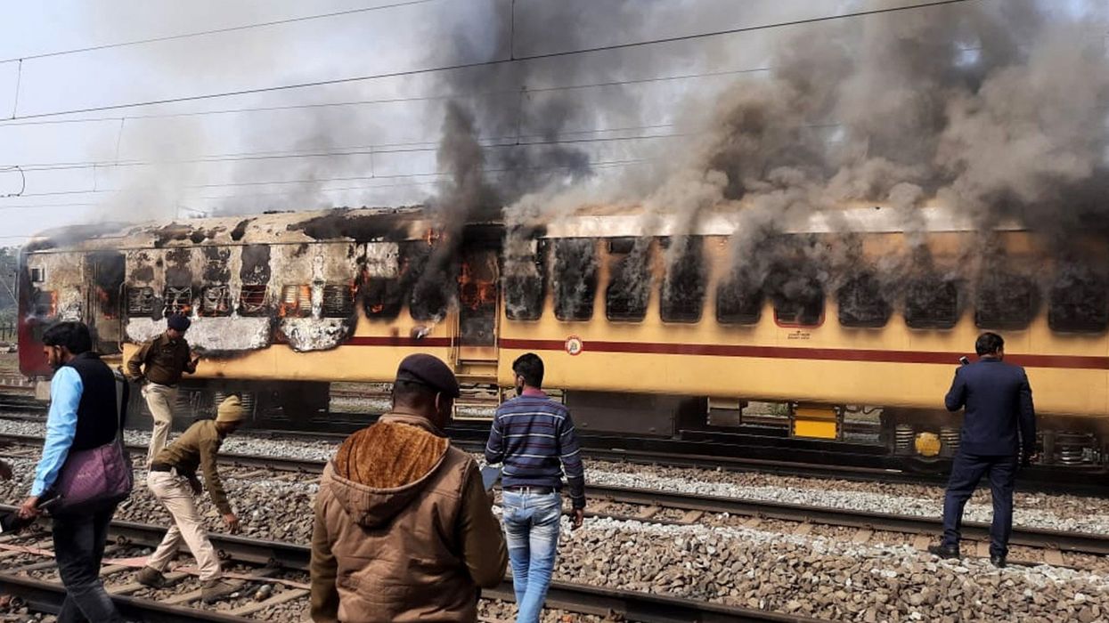 Mobs burn Indian train carriages in rail jobs protest