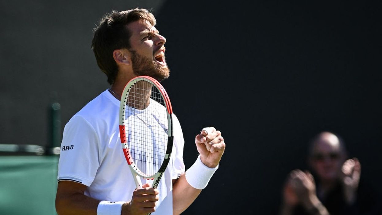 Britain's Norrie eases through after rain delay