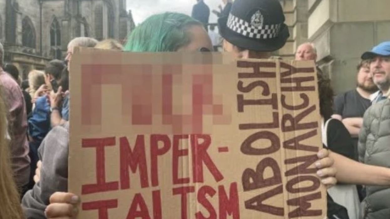 Anti-monarchy protester who was holding sign reading 'f*** imperialism, abolish monarchy' says her arrest violated freedom of speech