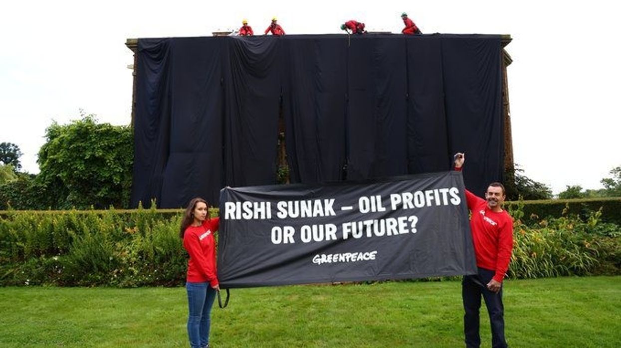Greenpeace protesters drape Sunak's home in black fabric over energy policy
