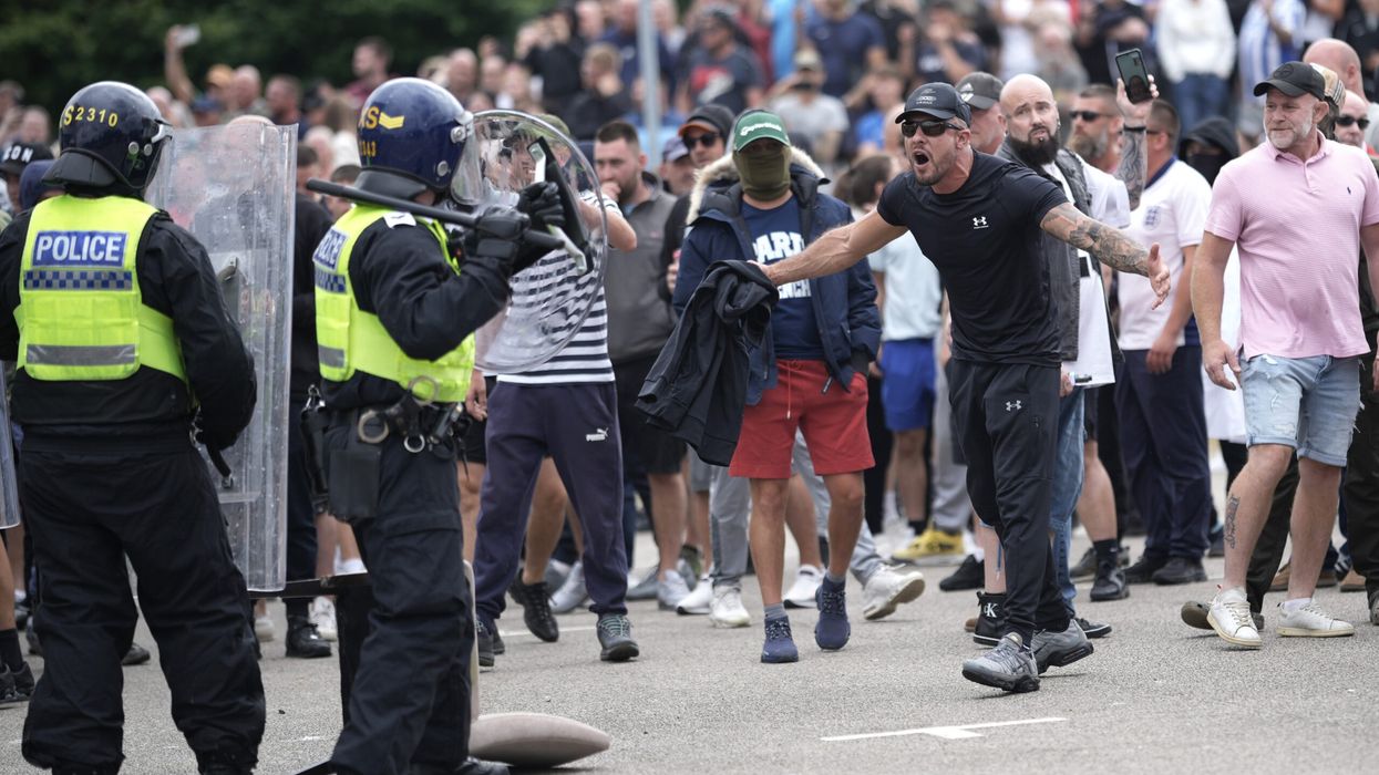 Finnish neo-Nazi linked to UK riots confronted by media