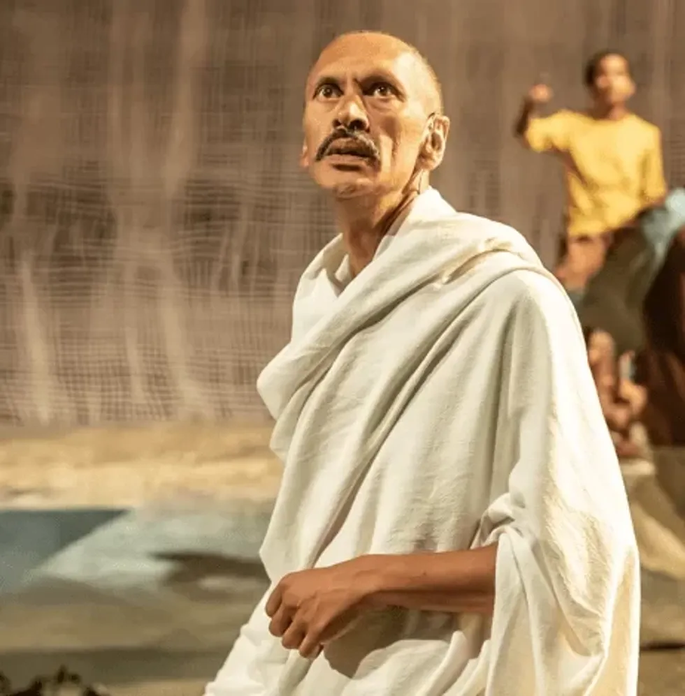INSET 1 Paul Bazely Mohandas Gandhi and company in The Father and the Assassin at the National Theatre 2023. Credits Marc Brenner 5387