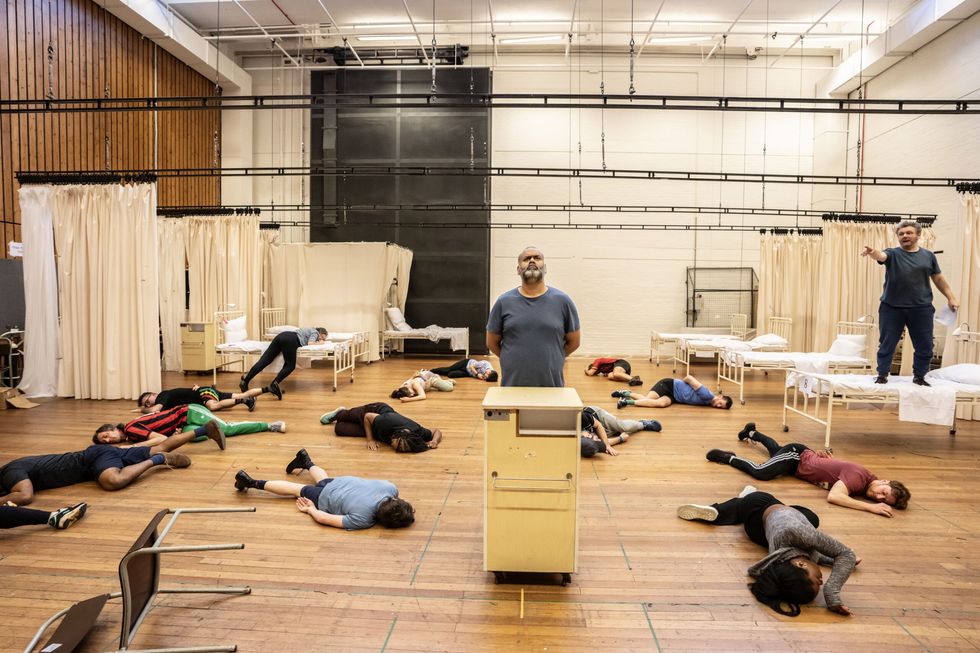 INSET 2 Optional Tony Jayawardena Doctor Dain and Winston Churchill Michael Sheen Nye Bevan and the Nye cast in rehearsal at the National Theatre. Photo credits Johan Persson