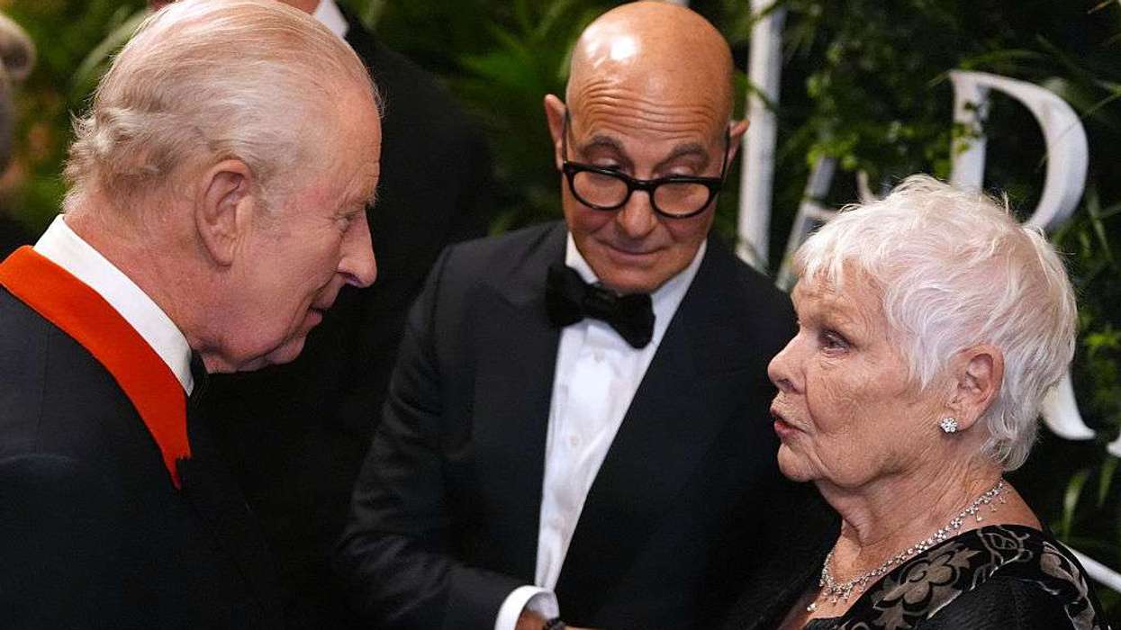 King Charles III speaks to Stanley Tucci and Dame Judi Dench