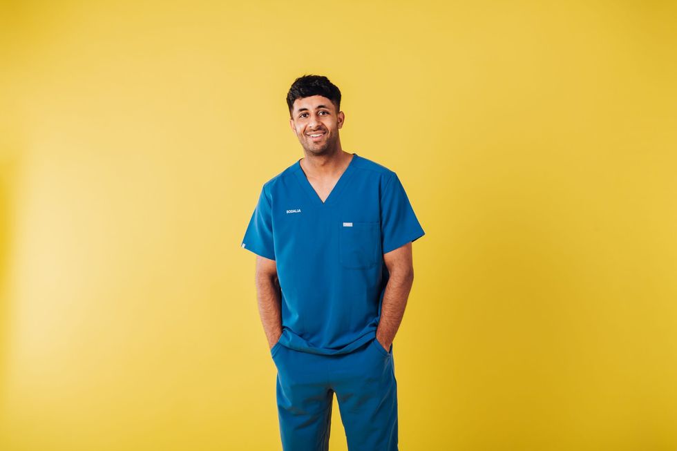 Lead inset DJ Bodalia in medical Scrubs yellow background