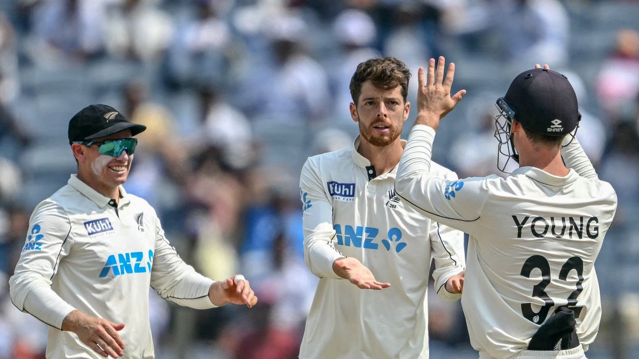 Mitchell Santner (C) celebrates with teammates after taking the wicket of  R Ashwin during the second day of the second Test. (Photo: Getty Images)