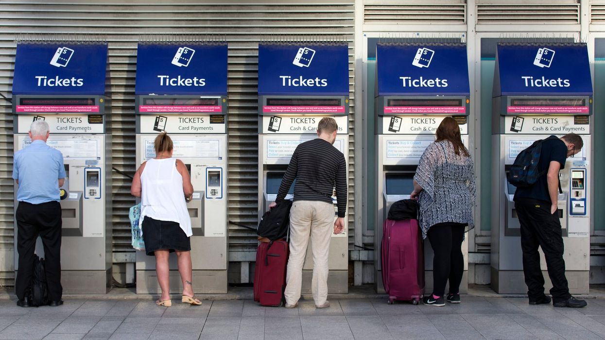 Morning commuters buy rail tickets from machines at London Bridge railway station. (Photo: Getty Images)