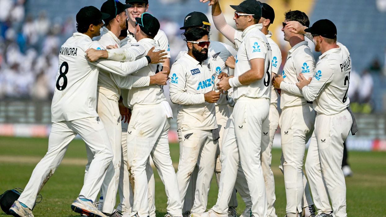 New Zealand players celebrate after their team's win against India at the end of the third day of their second Test cricket match in the Maharashtra Cricket Association Stadium of Pune on October 26, 2024. (Photo by Punit PARANJPE / AFP) / -- IMAGE RESTRICTED TO EDITORIAL USE - STRICTLY NO COMMERCIAL USE -- (Photo by PUNIT PARANJPE/AFP via Getty Images)