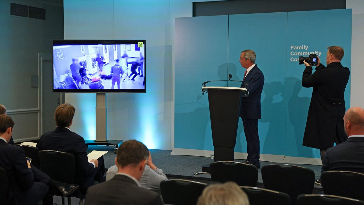 Nigel Farage watches a video taken from social media, showing the Manchester Airport fight, during a press conference on law and order in Britain, in London, on October 7, 2024. (Photo: Getty Images)