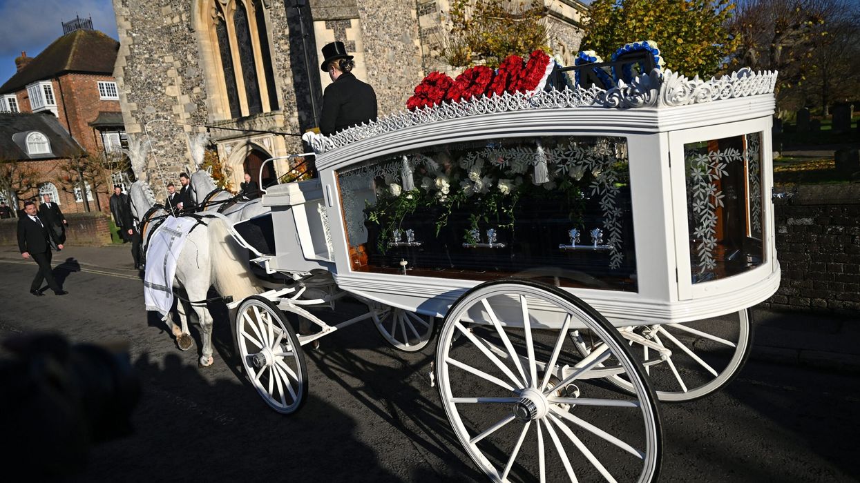 Payne’s coffin arrived in a white horse-drawn hearse adorned with floral tributes spelling 'Son' and 'Daddy,' followed by his parents. (Photo: Getty Images)