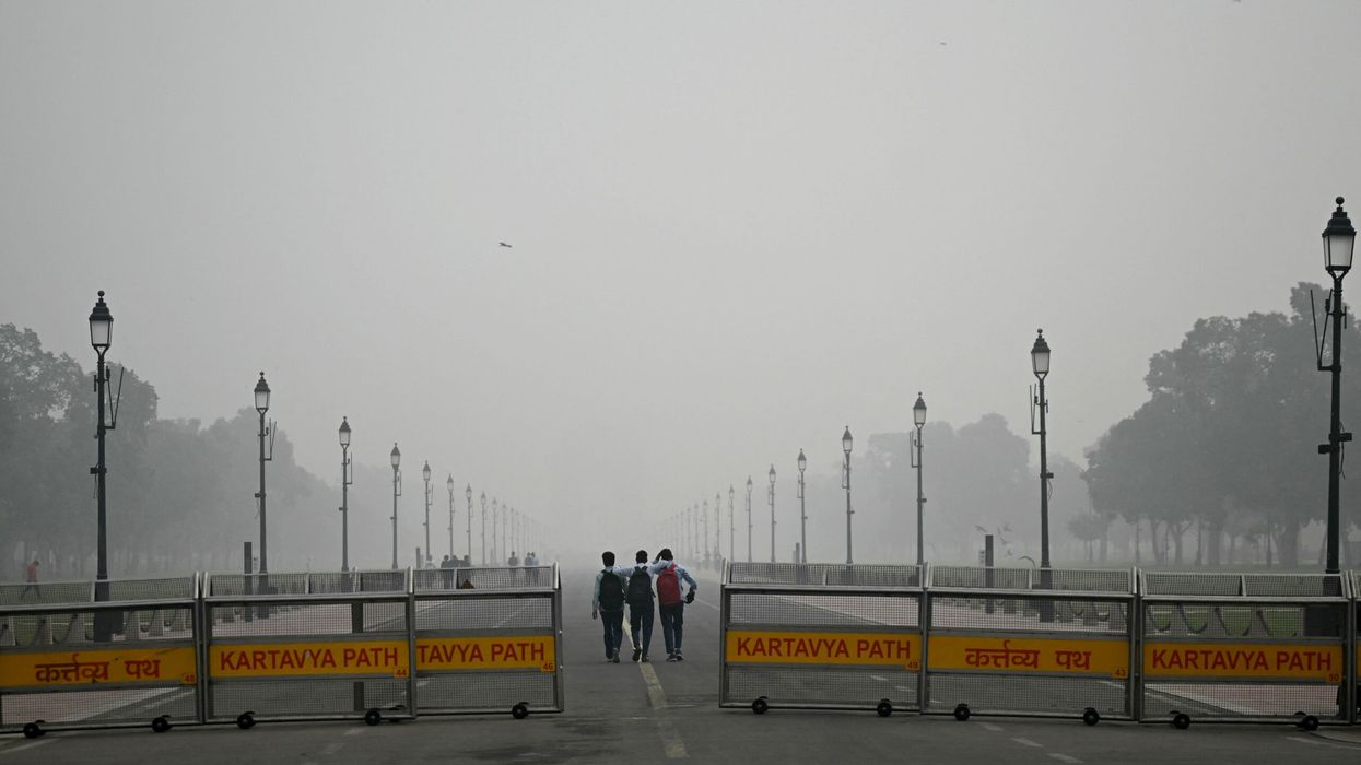 People walk along the Kartavya Path near India Gate engulfed in smog in New Delhi on November 13, 2024. (Photo: Getty Images)