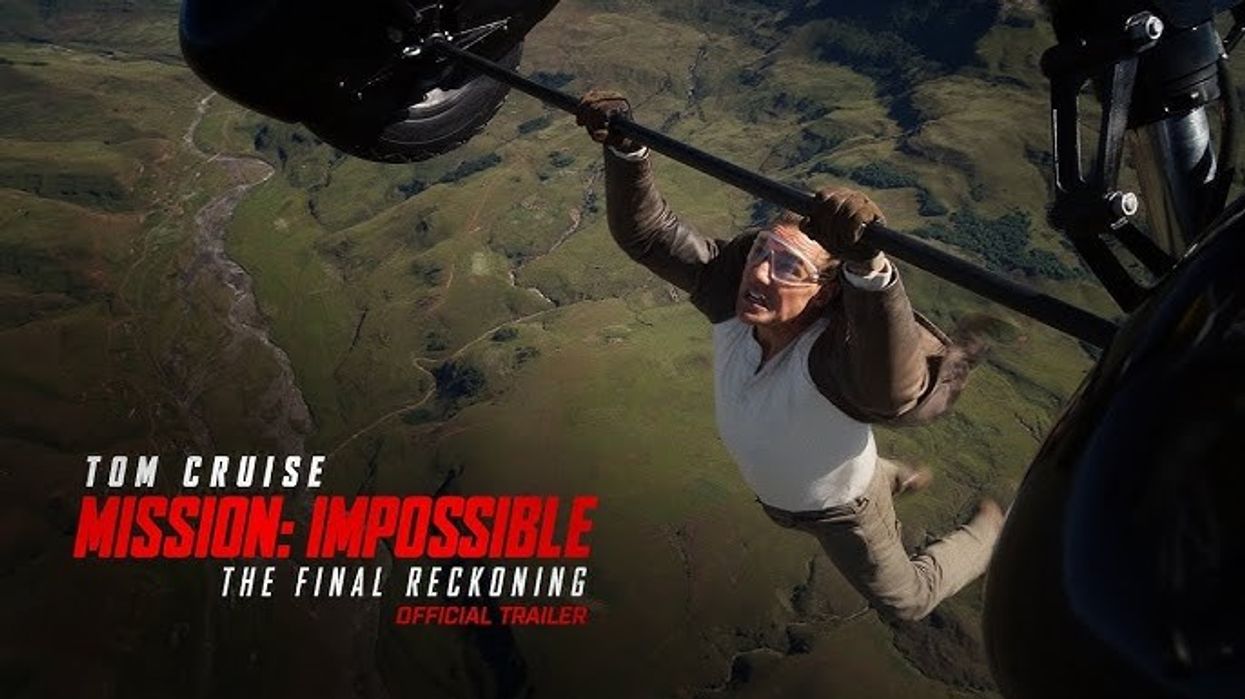 Tom Cruise as Ethan Hunt hanging from a plane