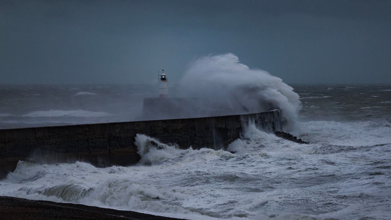 Waves crash over the breakwater on November 23 in Newhaven, England. (Photo: Getty Images)
