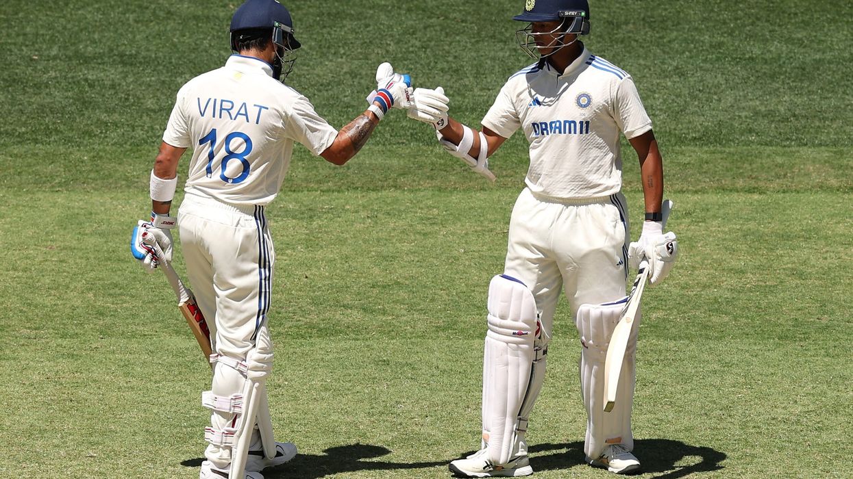 Yashasvi Jaiswal celebrates with Virat Kohli after reaching 150 runs during day three of the first Test between Australia and India at Perth on November 24. (Photo: Getty Images)