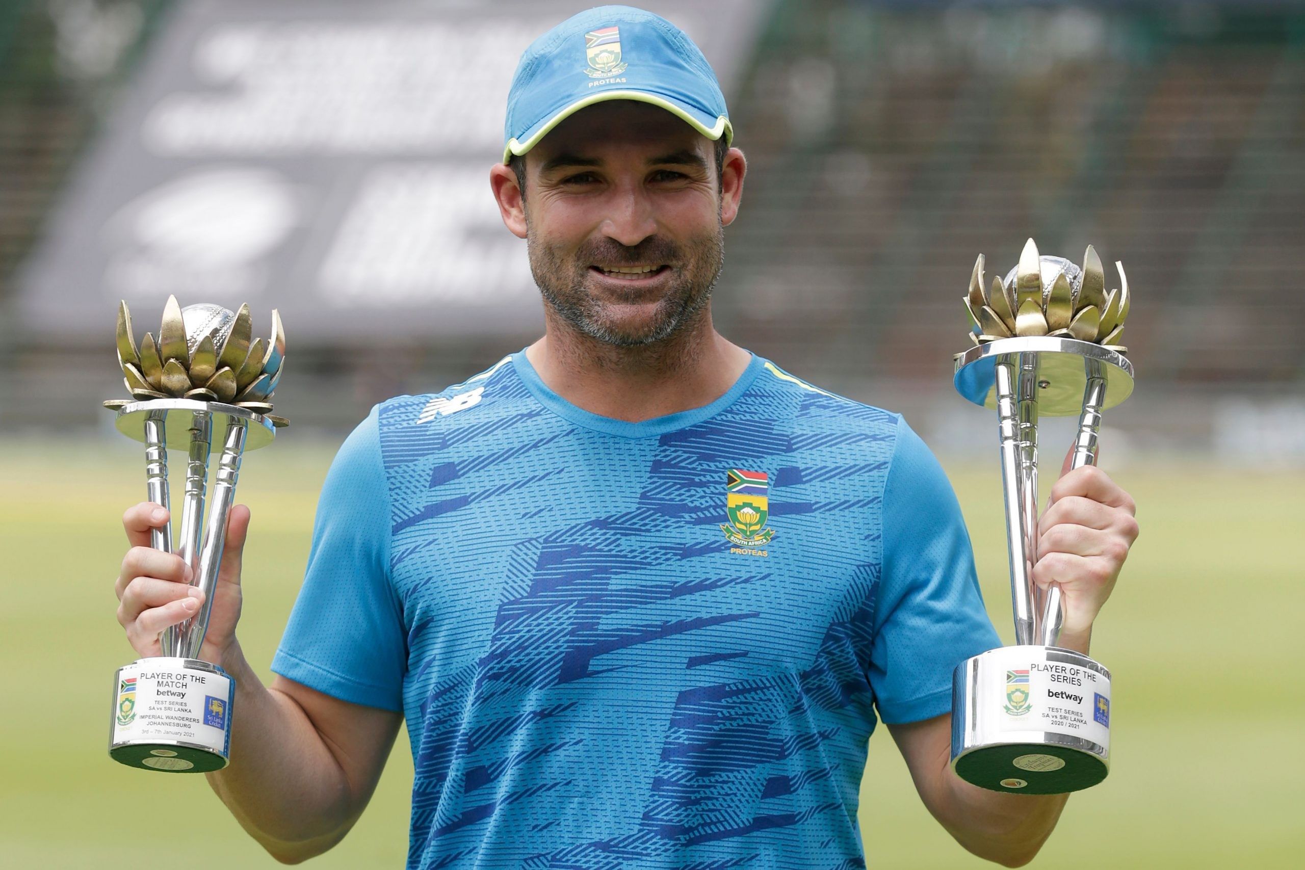 South Africa's Dean Elgar holds the trophies he received after being announced man of the match and man of the series during the third day of the second Test cricket match between South Africa and Sri Lanka at the Wanderers stadium in Johannesburg on January 5, 2021. (Photo by PHILL MAGAKOE / AFP)