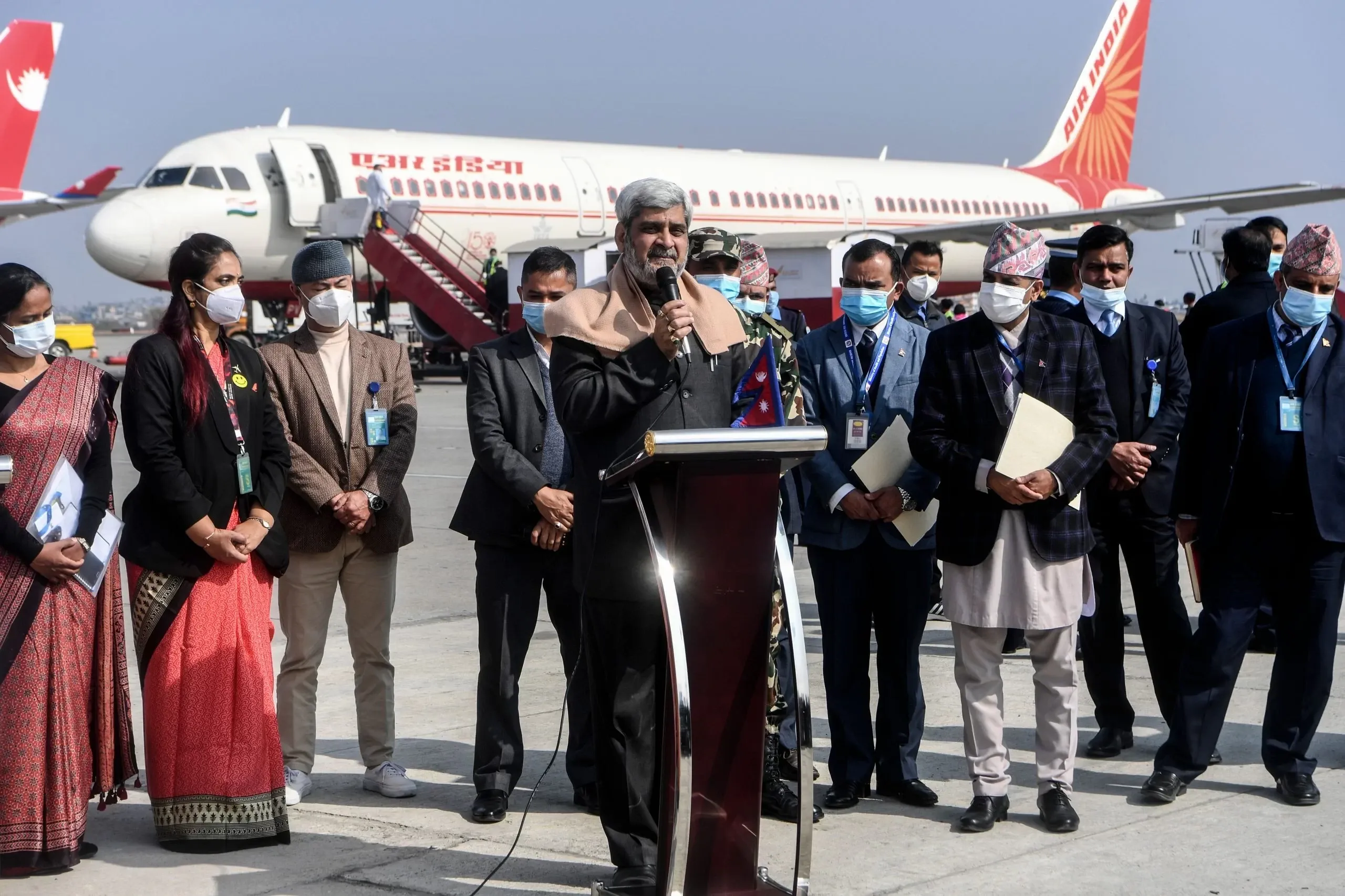 Nepal's Health Minister Hridayesh Tripathi (C) delivers his speech upon the arrival of Covishield, AstraZeneca-Oxford's Covid-19 coronavirus vaccine made by India's Serum Institute, from India at the Tribhuvan International Airport in Kathmandu on January 21, 2021. (Photo by Prakash MATHEMA / AFP)