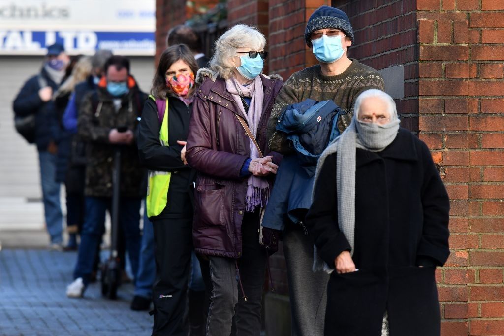 Members of the public queue to take coronavirus tests at a temporary COVID-19 testing facility set up in West Ealing in west London, on February 2, 2021, as increased testing is put in place to test residents for the South African variant of Covid-19. (Photo by JUSTIN TALLIS/AFP via Getty Images)