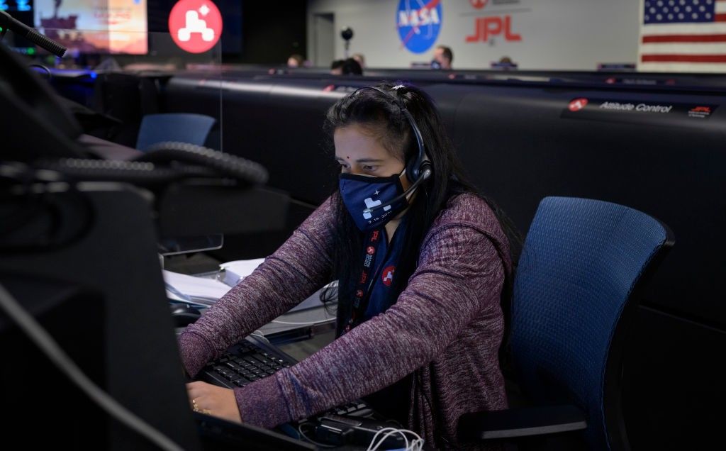 In this handout image provided by NASA, Perseverance Mars rover mission commentator and guidance, navigation, and controls operations Lead Swati Mohan studies data on monitors in mission control, February 18, 2021 at NASA's Jet Propulsion Laboratory in Pasadena, California. (Photo by Bill Ingalls/NASA via Getty Images)