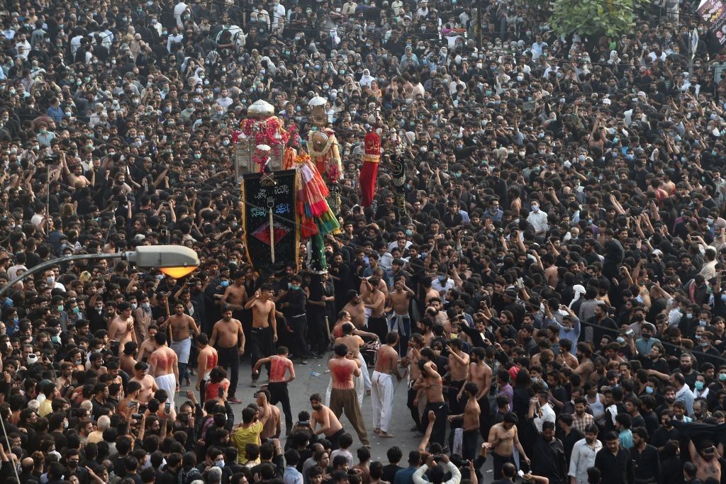 Shiite Muslim devotees take part in a procession to commemorate the death anniversary of Prophet Mohammad's companion and son-in-law Imam Ali in Lahore on May 4, 2021. (Photo by ARIF ALI/AFP via Getty Images)