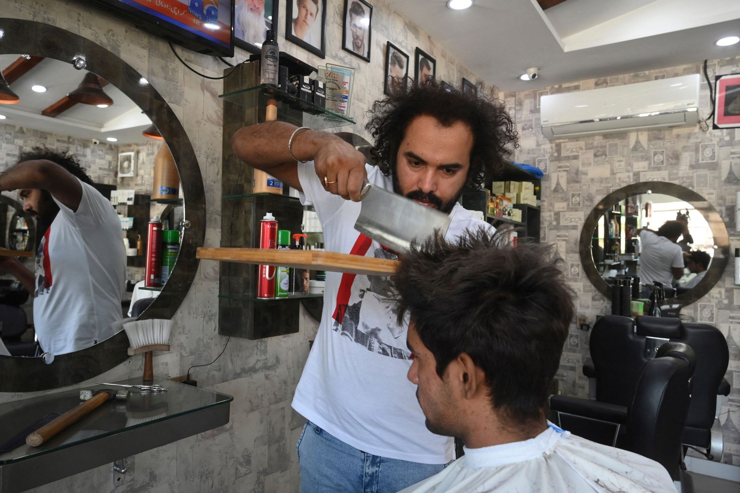 This Pakistan barber uses torch, meat cleaver to give hair cut EasternEye