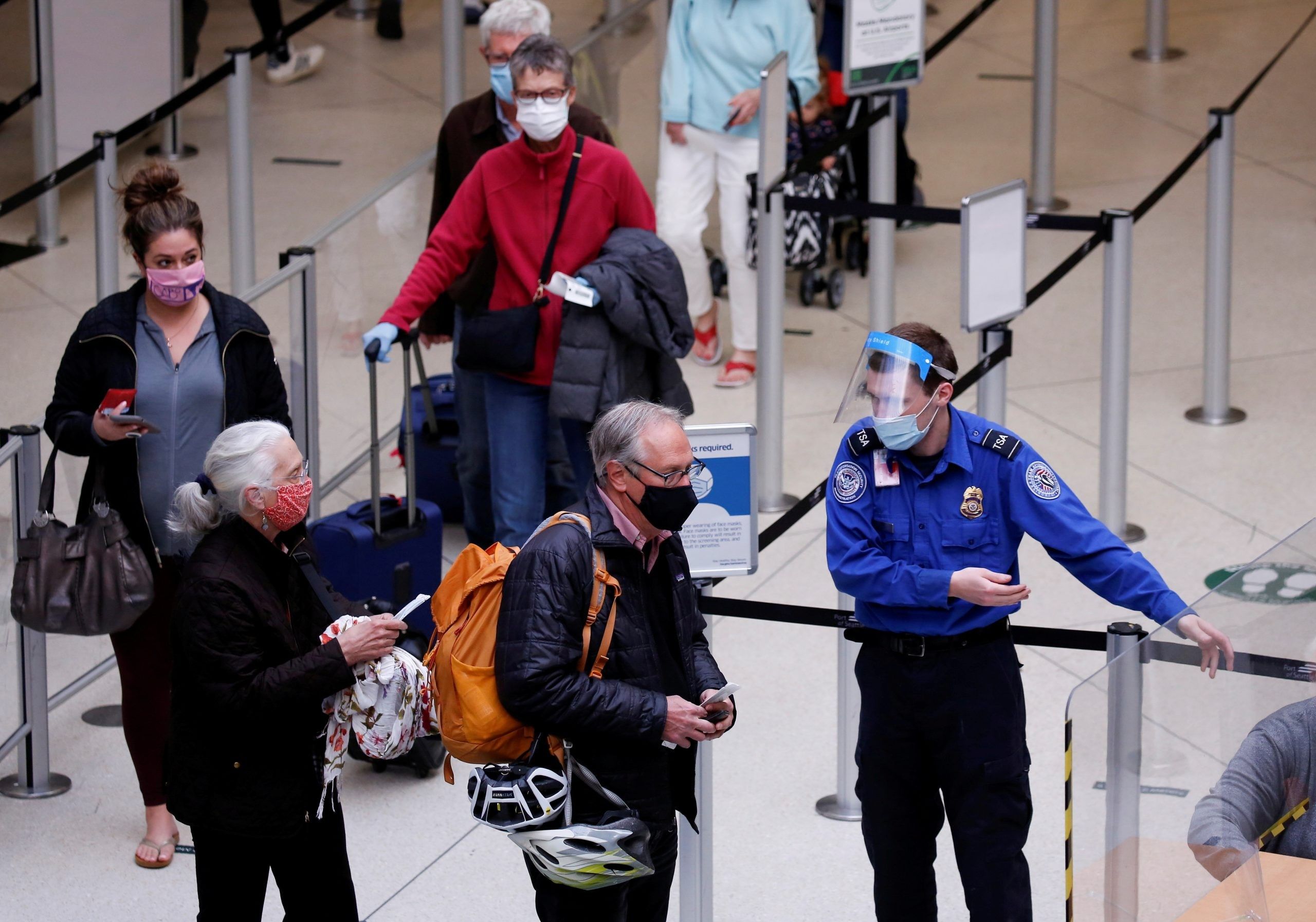 FILE PHOTO: A TSA worker directs travellers to the next station at a security checkpoint at Seattle-Tacoma International Airport in SeaTac, Washington. (REUTERS/Lindsey Wasson)