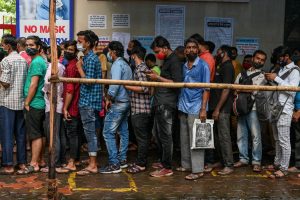 People queue up to get themselves inoculated with a dose of the Covaxin vaccine against the Covid-19 coronavirus, at a temporary vaccination centre set up inside a school in Mumbai on September 7, 2021..