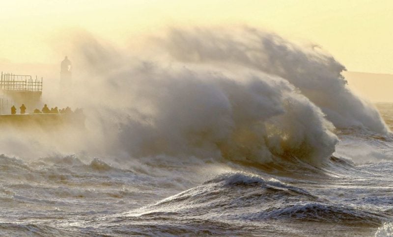 Waves crash against the sea wall at Porthcawl, south wales
