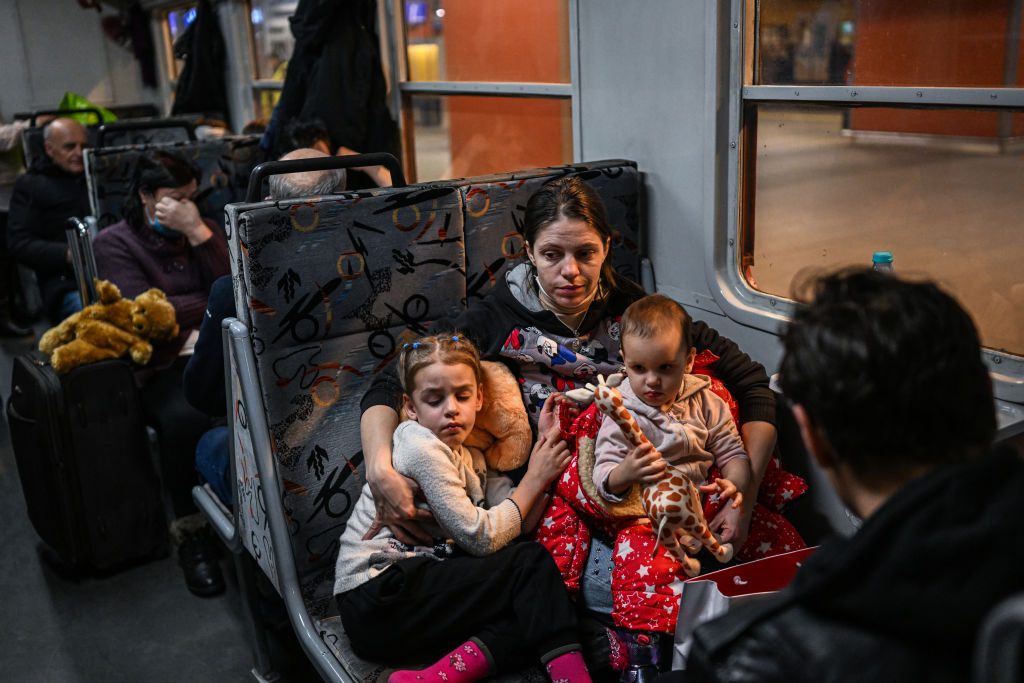 A woman and children who fled the war in Ukraine for the departure of a humanitarian train to relocate them to Berlin on March 18, 2022 in Krakow, Poland. 