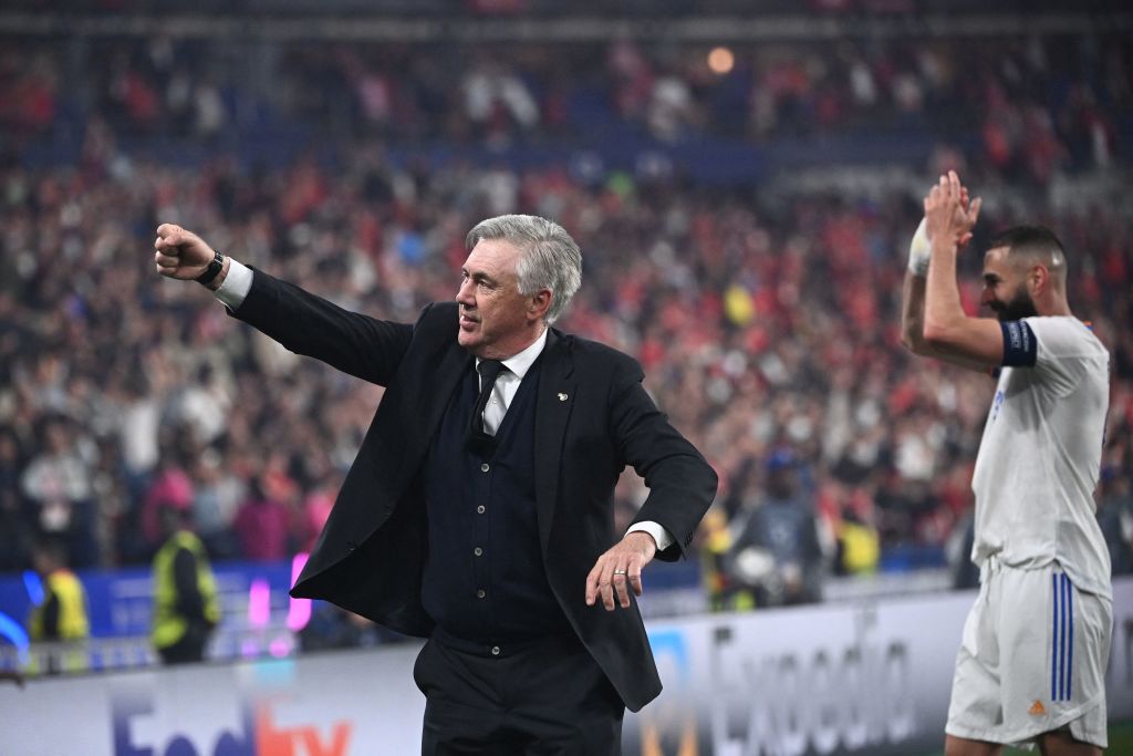 Real Madrid's Italian coach Carlo Ancelotti (L) and Real Madrid's French striker Karim Benzema (R) gesture after Real Madrid's victory in the UEFA Champions League final football match between Liverpool and Real Madrid at the Stade de France in Saint-Denis, north of Paris, on May 28, 2022