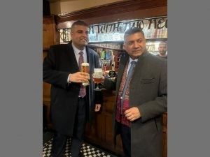 Indian high commissioner to the UK, HE Vikram Doraiswami (L), receives a framed gifted him a framed Stockport County shirt from Navendu Mishra MP in Stockport